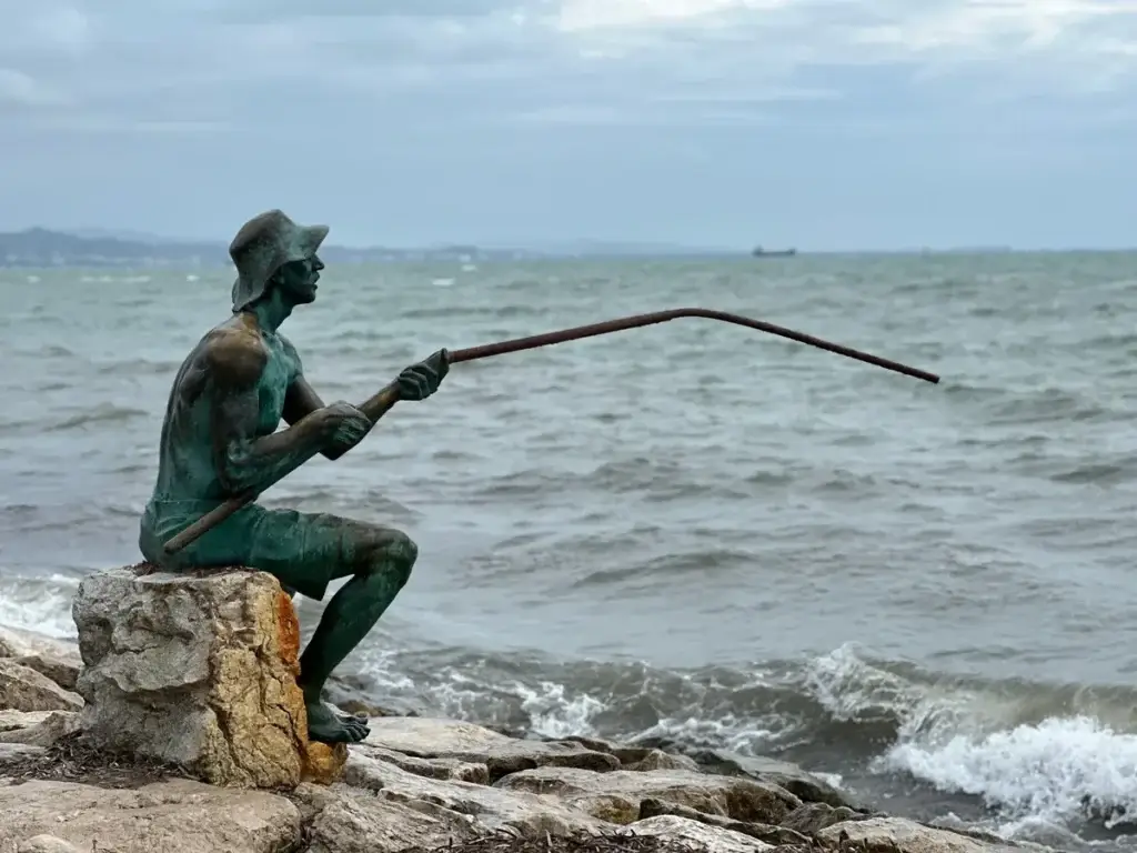 Bronzen standbeeld van een visser aan de kust van Durrës